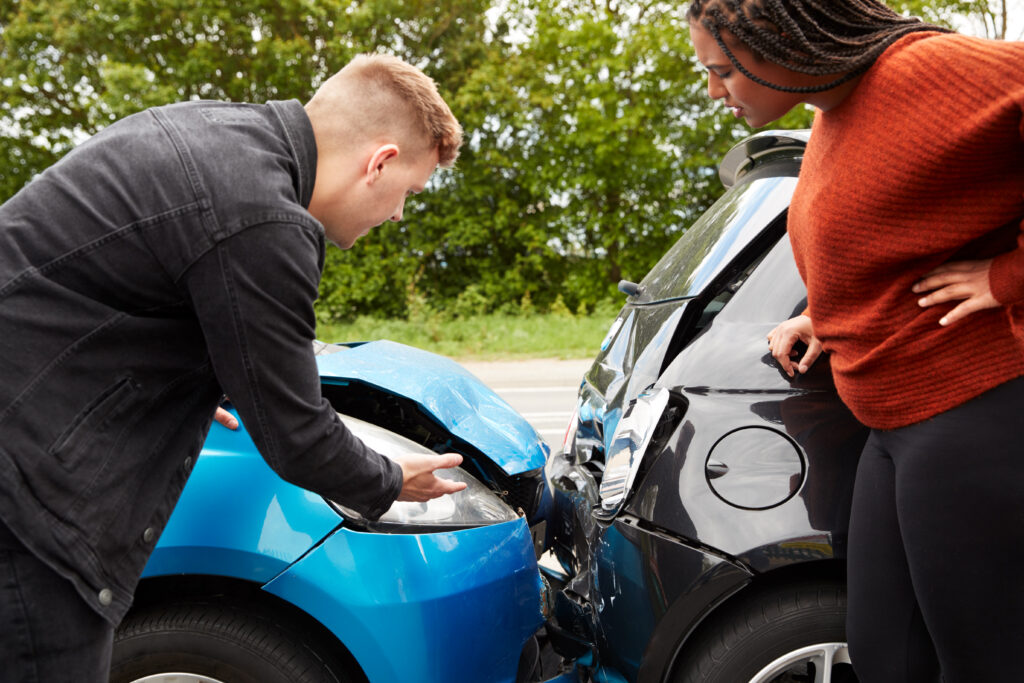 Drivers inspecting vehicle damage after a car accident