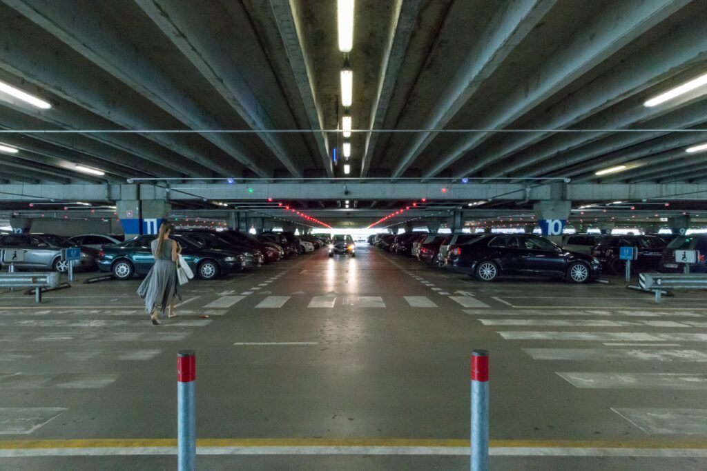 A pedestrian in a well-lit garage, illustrating safety guidelines and property owner duties under Florida premises liability laws.